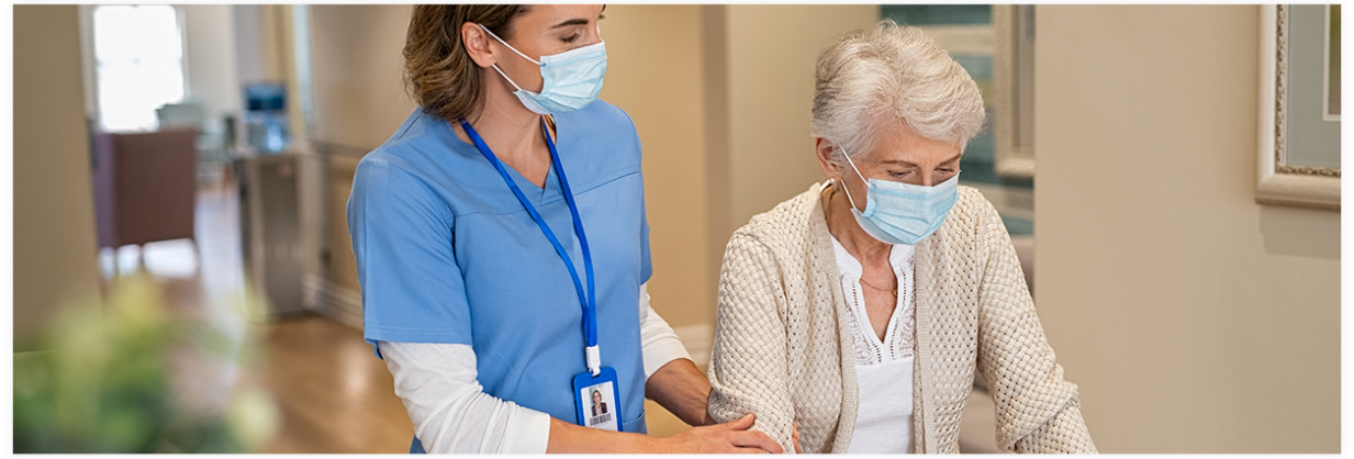 A nurse helping an elderly lady